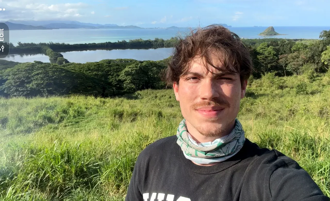 Hunter at an Oahu hiking overlook with the ocean behind him.