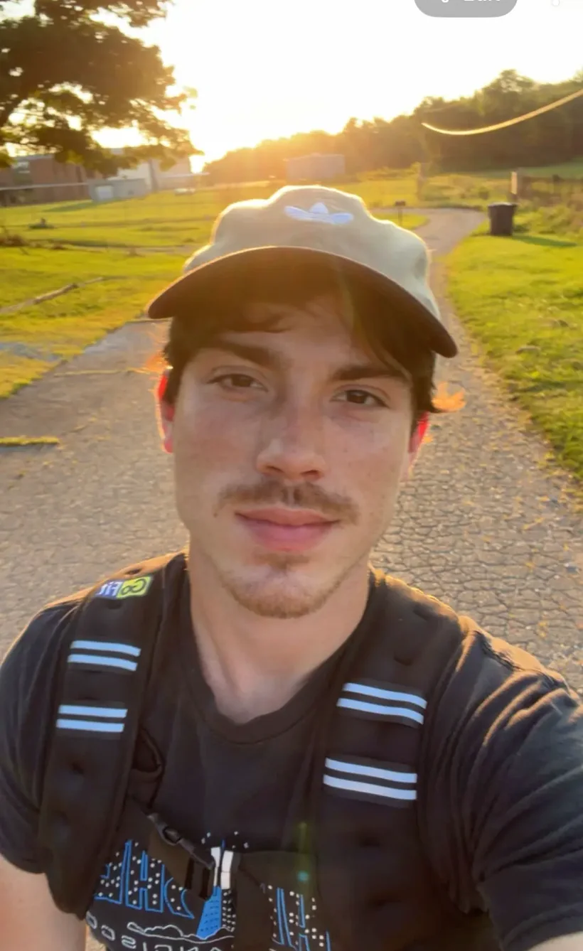 Hunter on a running path at sunset.